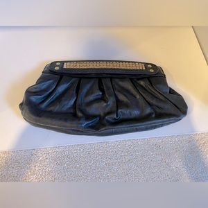 Black medium clutch with slight gold work on top flaps